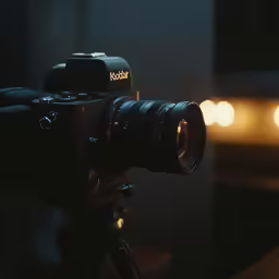 a camera is shown on a tripod with blurry lights in the background