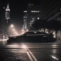 a car driving on the road near tall buildings at night