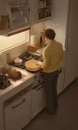 woman standing in kitchen preparing food on stove top