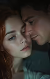 a young couple embracing each other looking down at the forehead