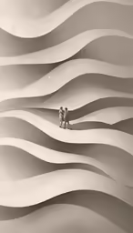 two people walking in a dune like area with ripples