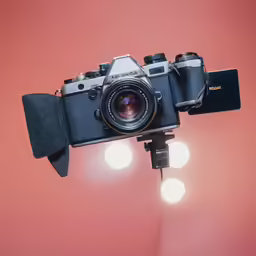 the back of an old - fashioned camera in front of a red wall