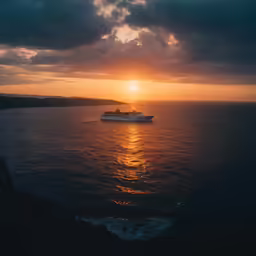 a boat is traveling along the water at sunset