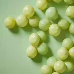 grapes on green and yellow background with water drops