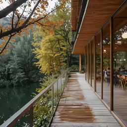 wooden deck in front of a glass walled, shaded area