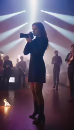 a woman with camera standing on stage