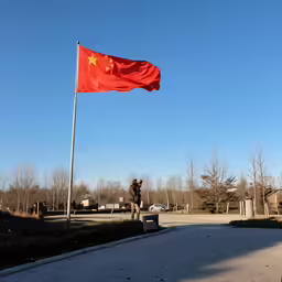 a flag flying over an empty parking lot