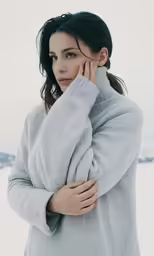 a woman is posing for the camera with her hand on her head