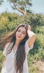 young woman in dress posing outdoors with long hair