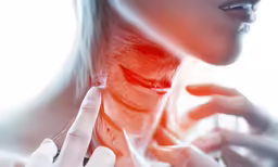 a woman in white gloves holds her neck up