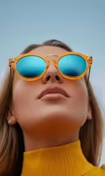 a woman wearing bright yellow clothes, blue sunglasses