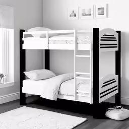 a white bunk bed sitting on top of a hard wood floor