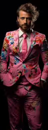 a man with white hair in a pink suit,a man in a bright pink suit stands with his hand on his hip