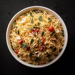 pasta in a white bowl with spinach and tomatoes