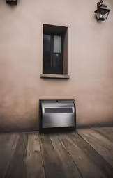 a metal toaster sitting on top of a wooden floor