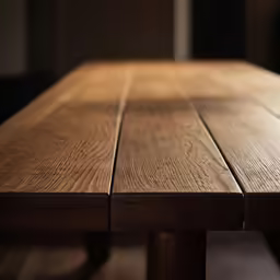 a wood table top is partially finished by someone