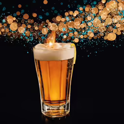 a beer glass filled with liquid and some bubbles