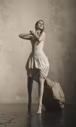 a woman in white dress holding an umbrella