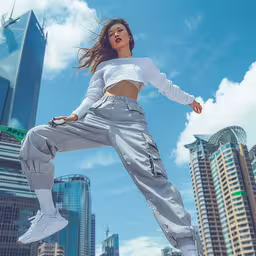 a woman jumps in the air with buildings behind her,woman wearing white sneakers jumping in the air