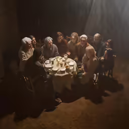 this is a group of people sitting around a table together