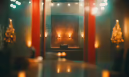 candles on the wall with blurred lights reflected off of them