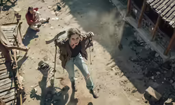 a woman is walking through an area full of rubble