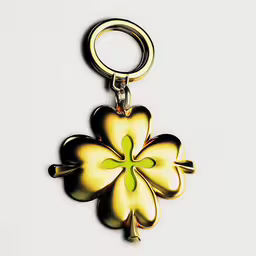 a gold keychain with four leaf shaped flower in the center,a flower that has been cut out to resemble four leaf clovers