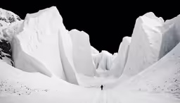 a lone man stands on a snowy landscape