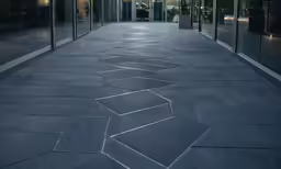 the exterior of an office building, which has a design on the sidewalk