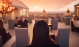 woman watching restaurant setting at sunset in the open