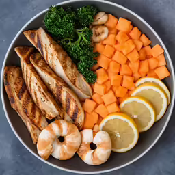 a plate of food consisting of lemons, broccoli, and cut up seafood