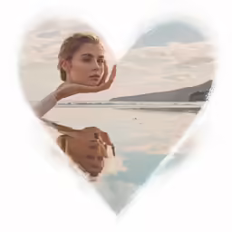 a woman holding a heart shaped image over her face
