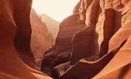 a canyon surrounded by large rocks with mountains in the background