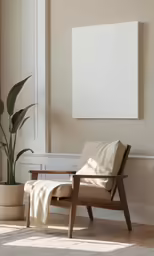 an empty chair and plant in a white room