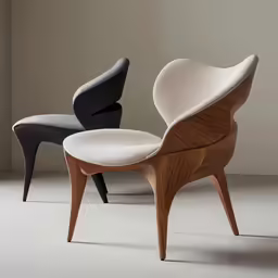 an egg chair with a ottoman, in black and white