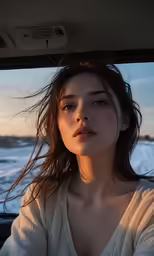 a girl looks out the window of a car