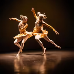 two girls dressed in yellow dancing with each other