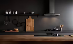 a modern kitchen with dark grey walls and black counter tops