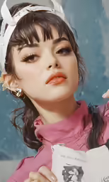 the woman is holding a piece of paper while staring away from her face