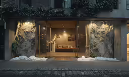 a person walks out of an office window at night