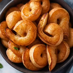 there are donuts that have been fried together in a bowl