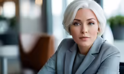 the woman is sitting down looking at something