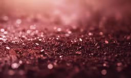 a background with a glitter texture and some sort of water drop