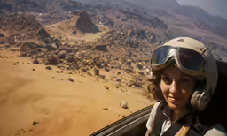 a person flying through the air near mountains