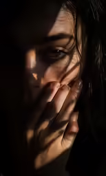 a woman that has her hand covering her face