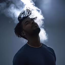 a man stares up into the sky at a cloud