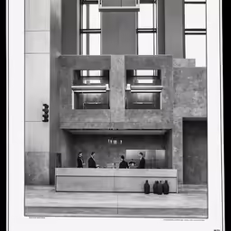 an empty office building with people standing around the counter