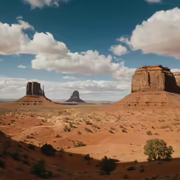 landscape view of mountains and deserts near an isolated monument