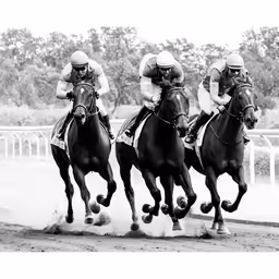 three horse jockeys are running together while they are about to leave the track