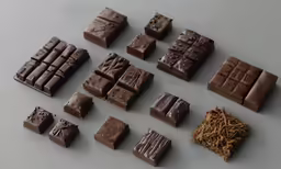 a table topped with lots of pieces of chocolate